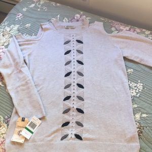 Knit sweater with cutouts on shoulder and neck